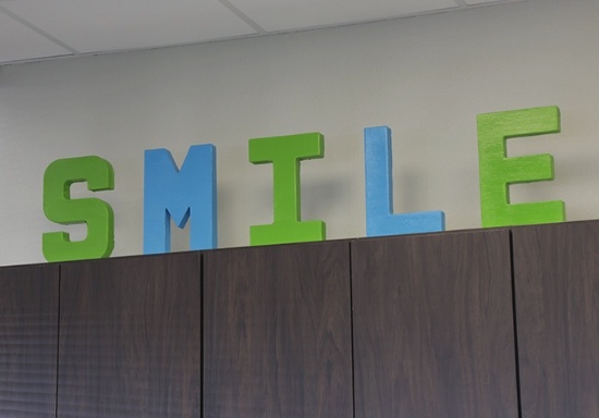 Sign reading smile on top of cabinet