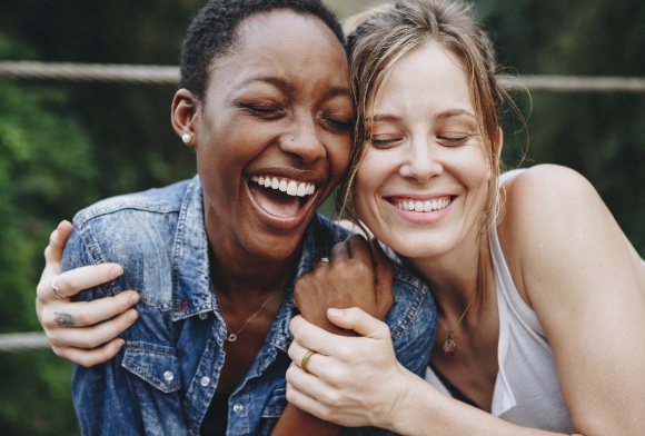 Two women smiling after tooth colored filling treatment