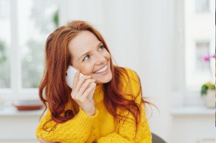 Woman smiling while talking on phone